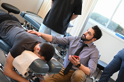 An instructor demonstrating to a group of students